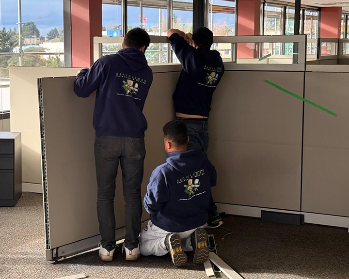Coordinated team effort moving panels and cubicle components