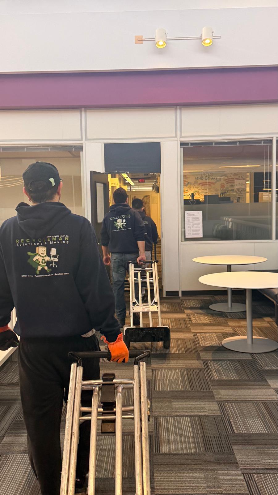 RM crew using hand trucks to move office furniture efficiently